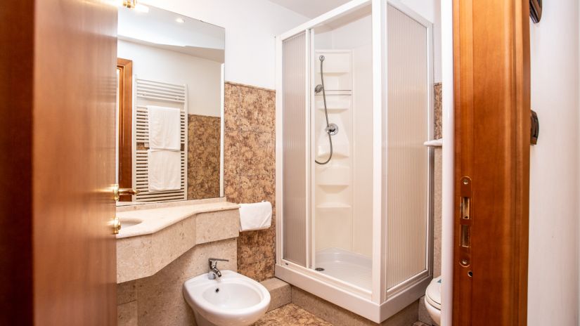 Bathroom with shower, washbasin, and bidet